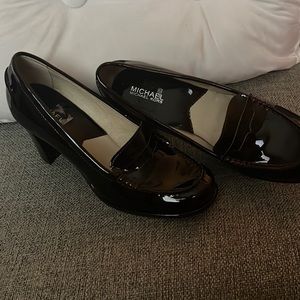 Michael Kors casual brown shoe with heel, with red stitching around the shoe.